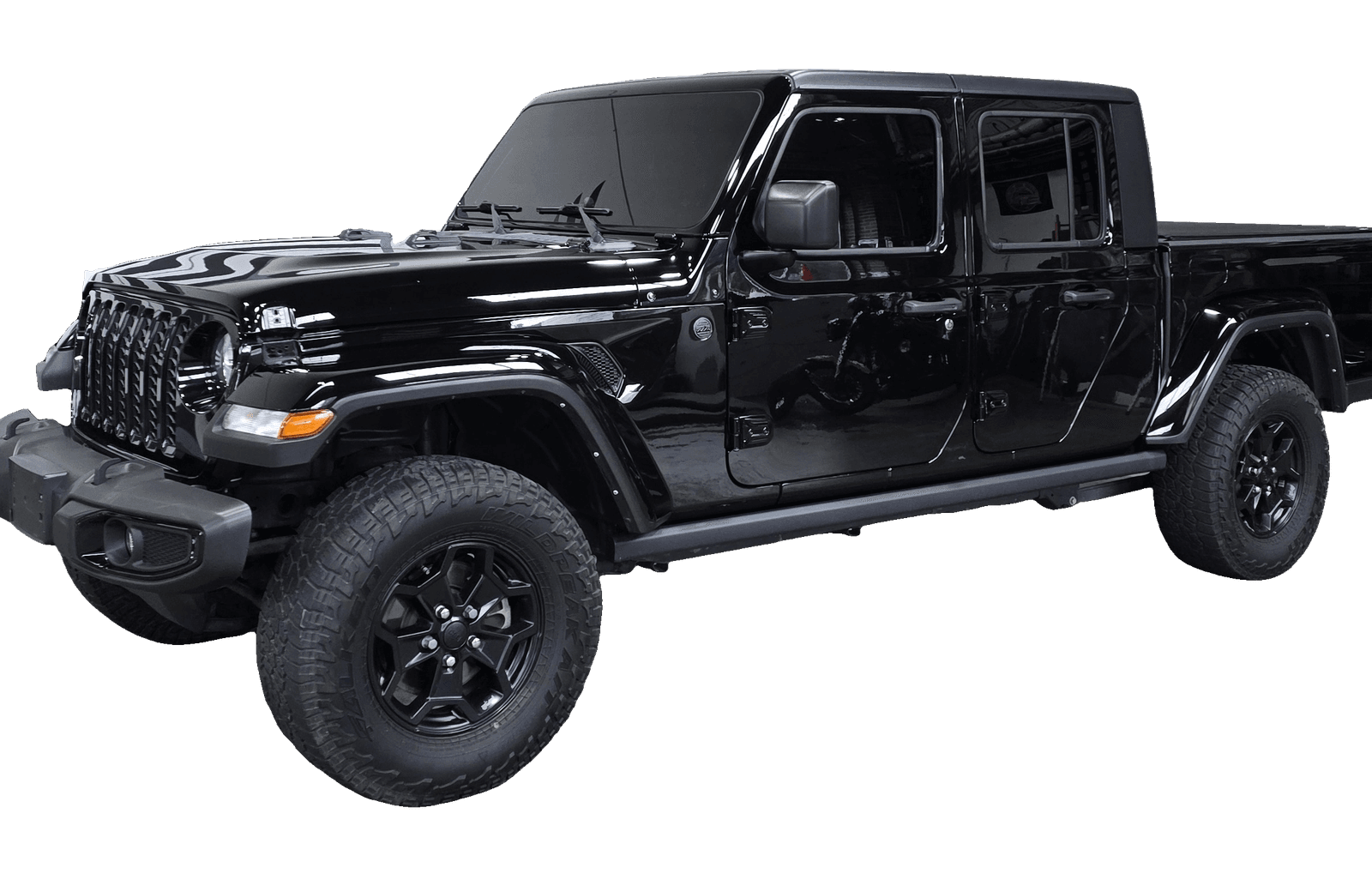 A blacked out Jeep Gladiator with a deep, mirror-flat finish after paint correction at Mr. G's Auto Care in Westminster, MD