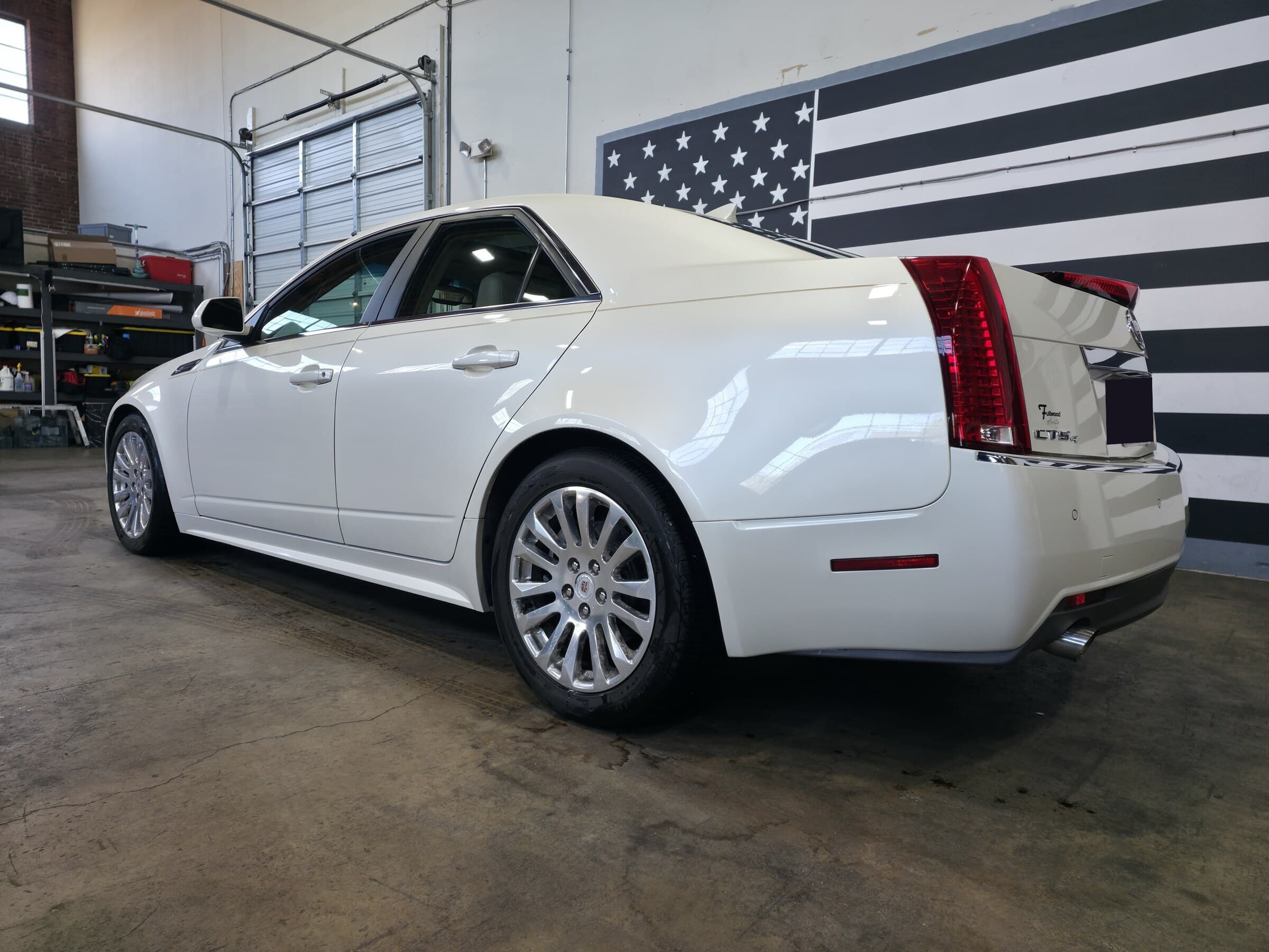 A ceramic coated white Cadillac CTS with a deep, mirror-flat finish at Mr. G's Auto Care in Westminster, MD