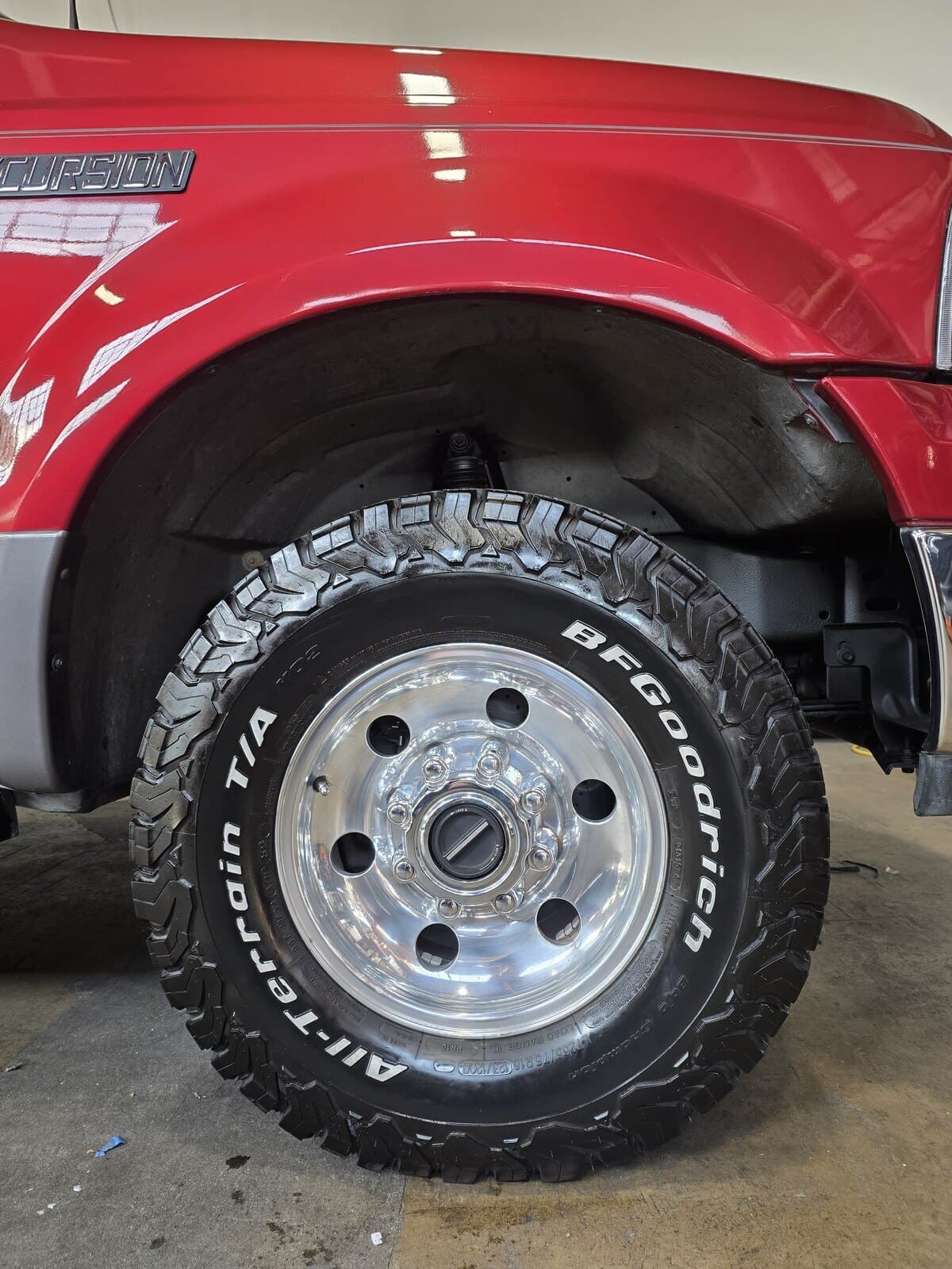 A clean polished wheel and dressed tire on a Ford Excursion after a full detail in Carroll County, MD