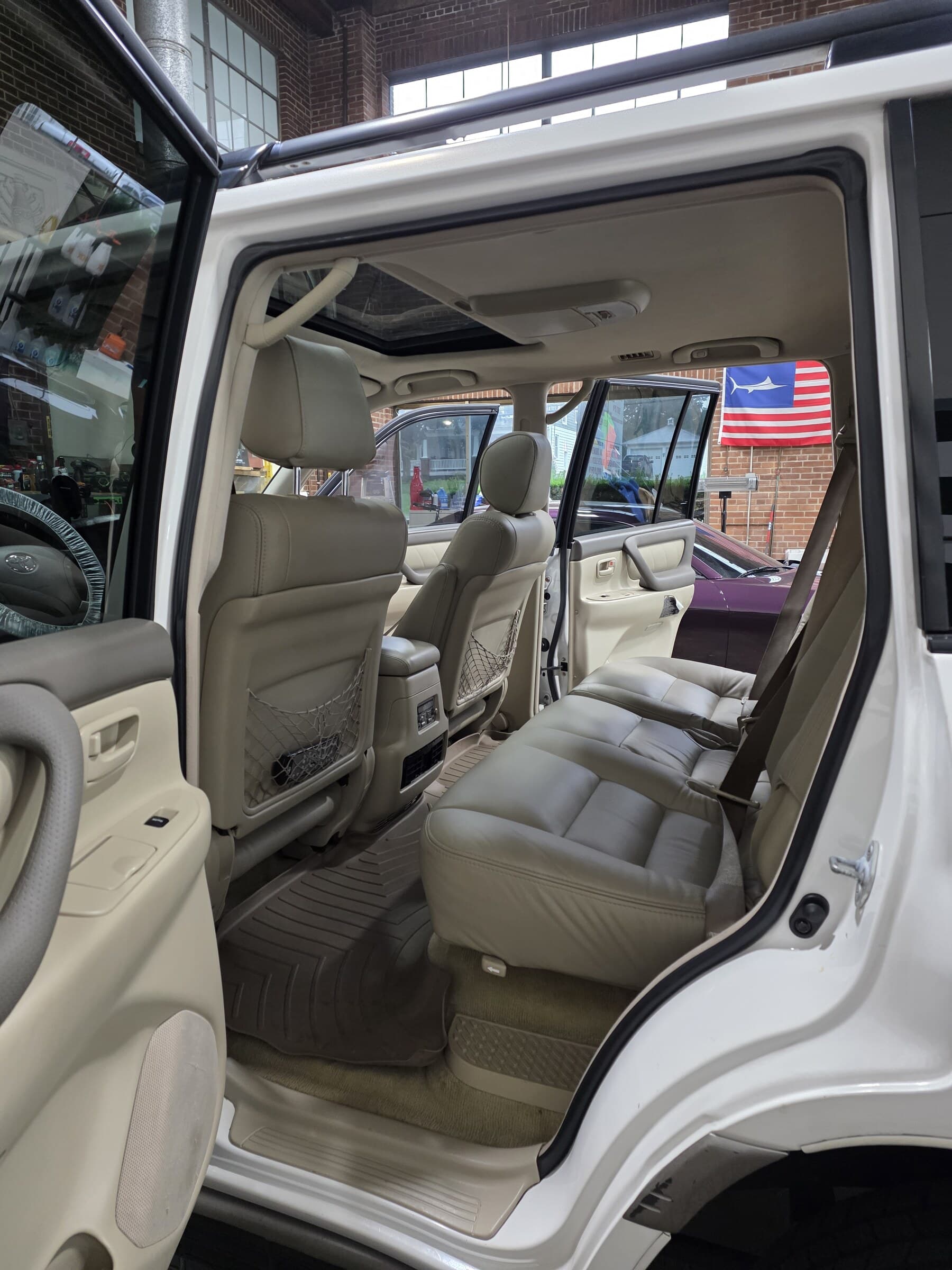 Spotless cream leather seats in a Toyota Land Cruiser after a full interior detail at Mr. G's Auto Care in Westminster, MD
